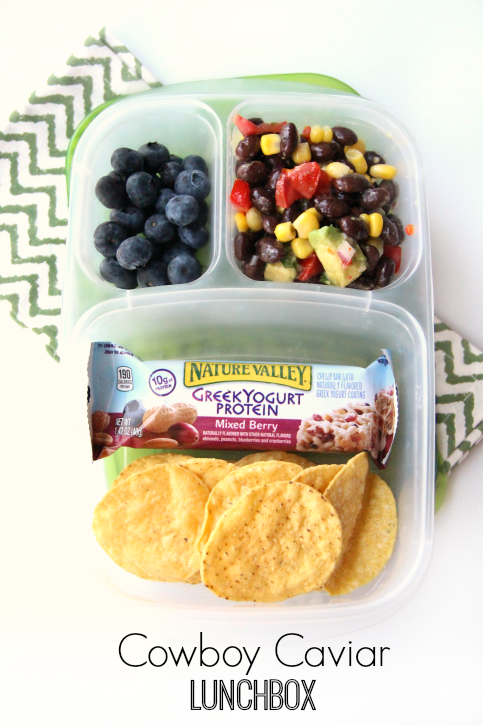  cowboy caviar packed in a lunch box with blueberries, chips and a granola bar