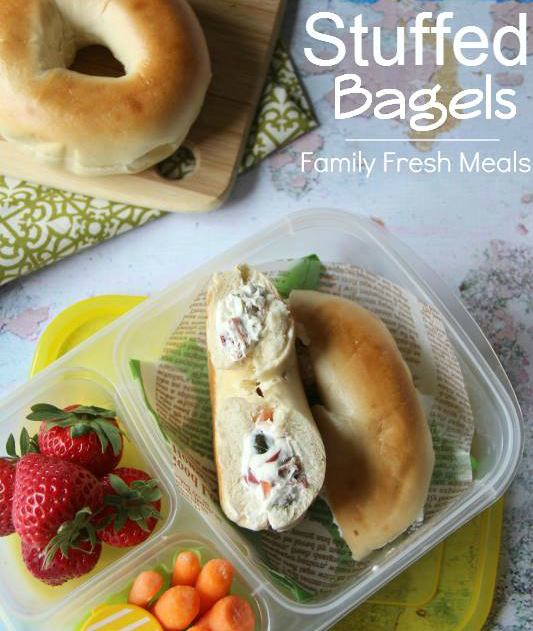 Stuffed Bagel packed in a lunch box with strawberries and carrots