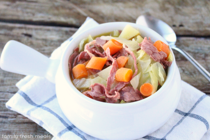 Corned Beef and Cabbage Soup served in a white soup bowl.