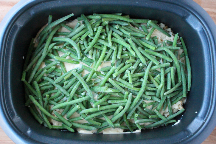 Creamy Crockpot Chicken Stuffing and Green Beans - Frozen green bean placed in black slow cooker