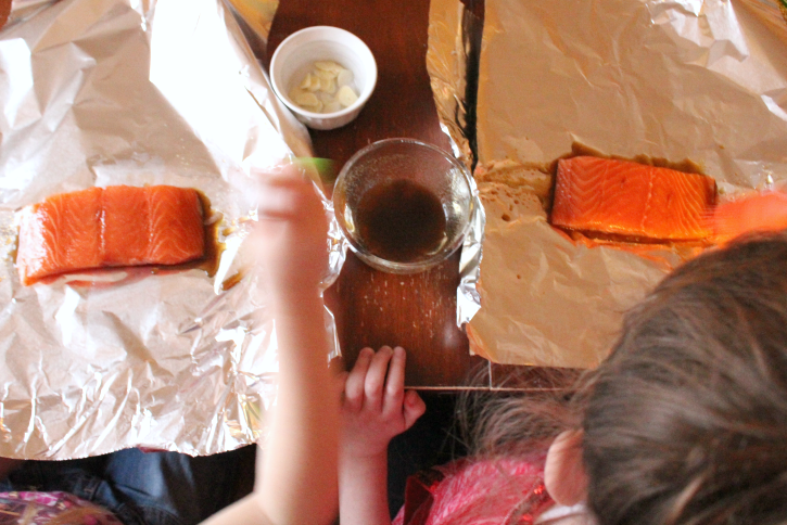 2 children making Easy Salmon Foil Packets 