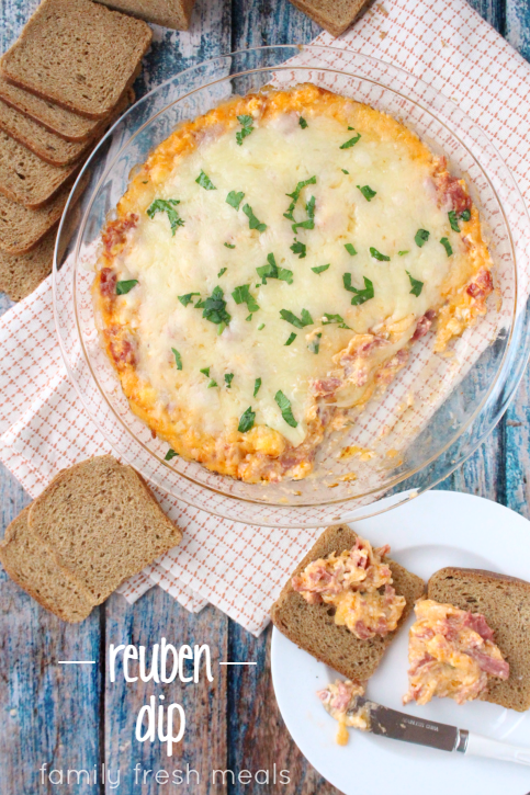 Reuben Dip served with small toasts on a white plate