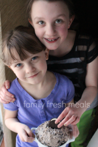 Two children holding a bowl of Creamy Oreo Dip Dessert 