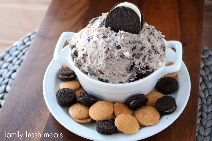 Creamy Oreo Dip Dessert in a white bowl, surrounded by cookies