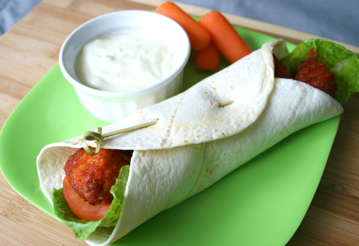 Easy Buffalo Chicken Wrap on a green plate with veggies and dip