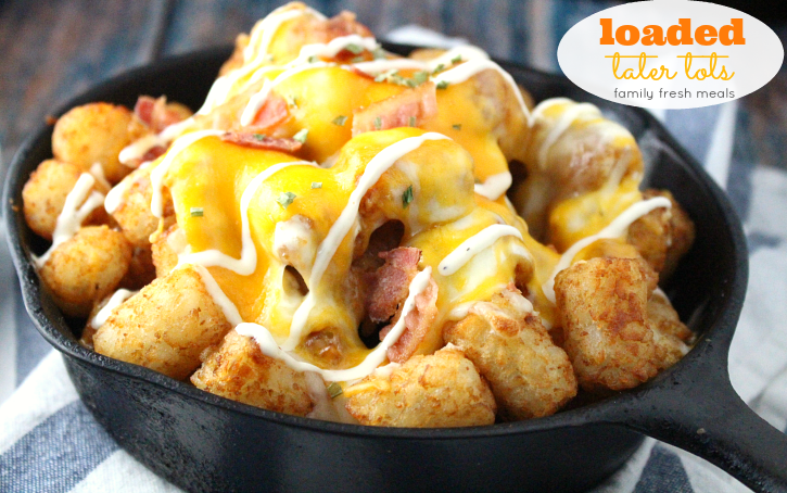 Loaded Cheesy Tater Tots in a cast iron skillet