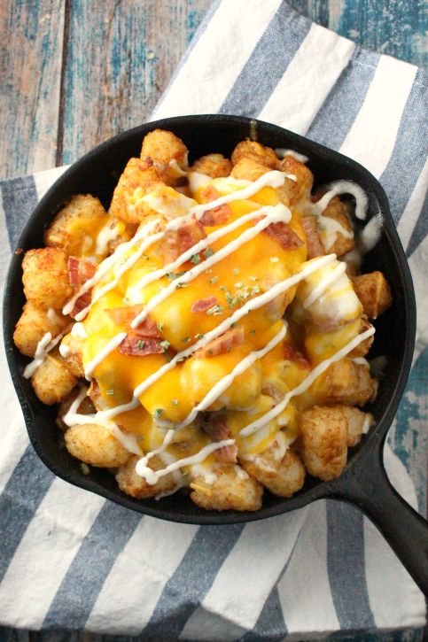 Loaded Cheesy Tater Tots served in a skillet