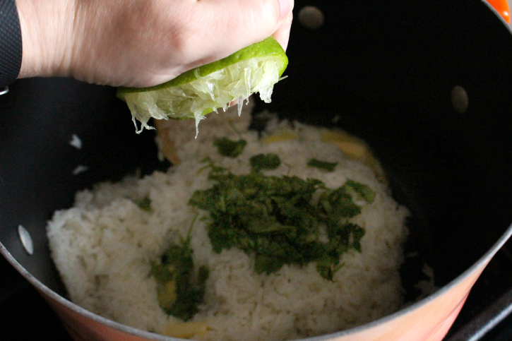 squeezing a lime into rice pot