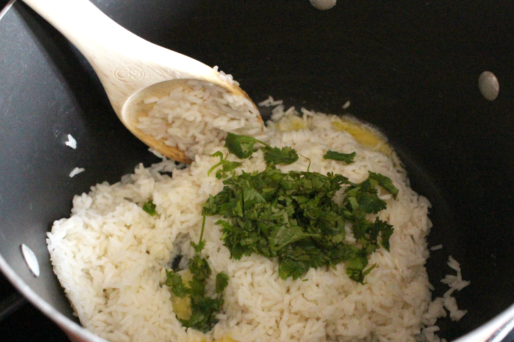 wooden spoon stirring Cilantro lime rice