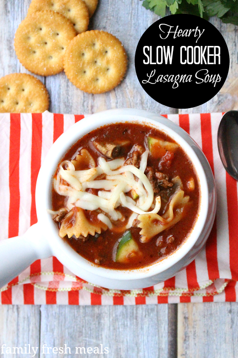 Hearty Slow Cooker Lasagna Soup in a white bowl with a side of crackers