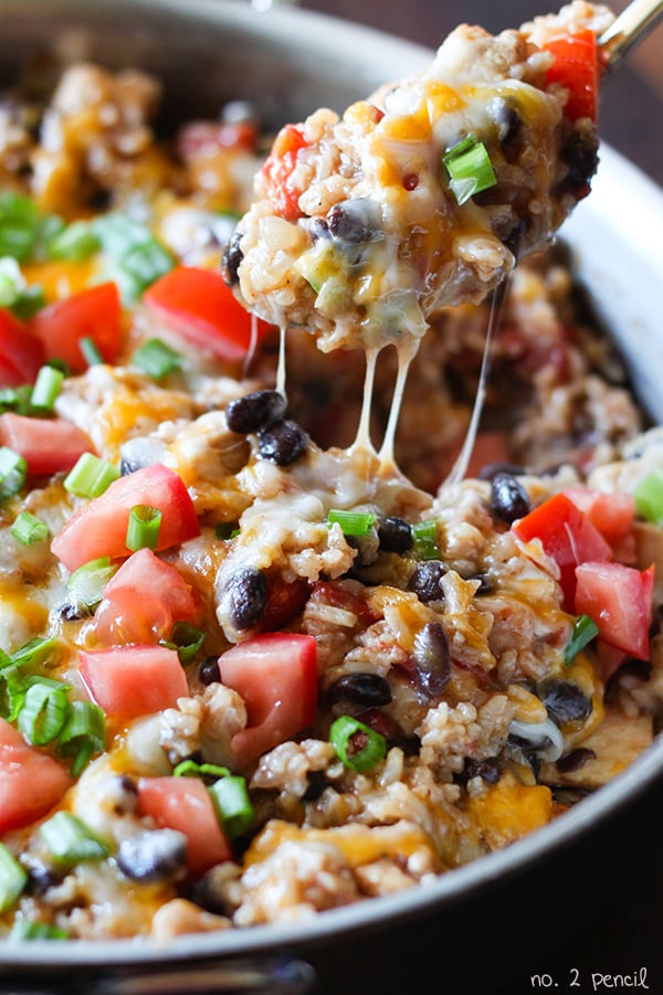 One Pot Mexican Casserole in a white dish with a spoon scooping some out