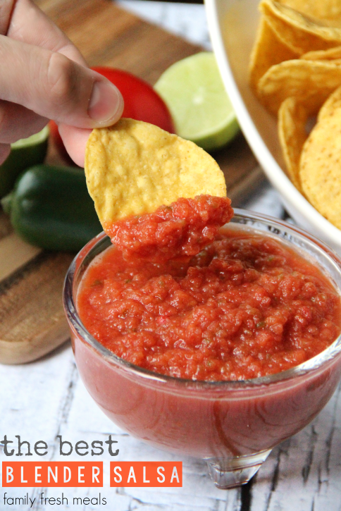 Tortilla chip scooping up some salsa