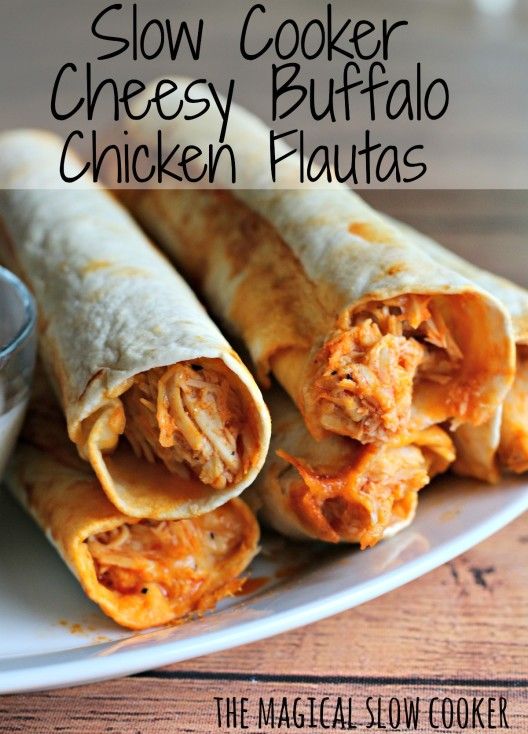 Slow Cooker Buffalo Chicken Flautas  stacked on a white plate