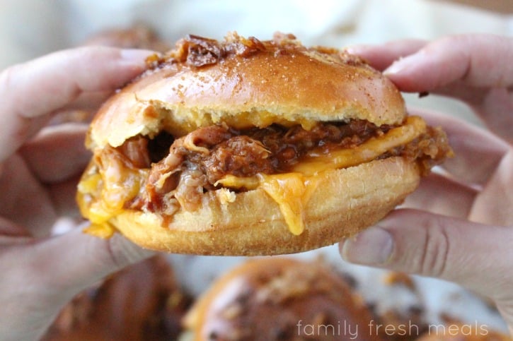 Hand holding a Baked BBQ Pulled Pork Sandwich