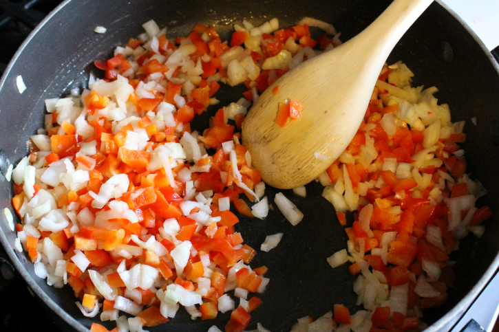 cooking onions and bell peppers in a large skillet