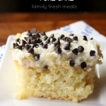 Piece of Cannoli Poke Cake Enjoy on a white plate