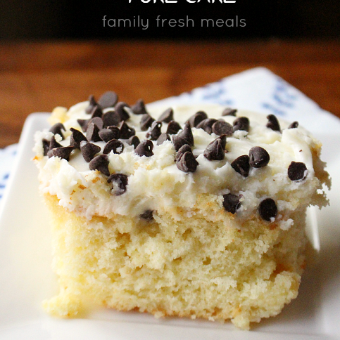 Piece of Cannoli Poke Cake Enjoy on a white plate