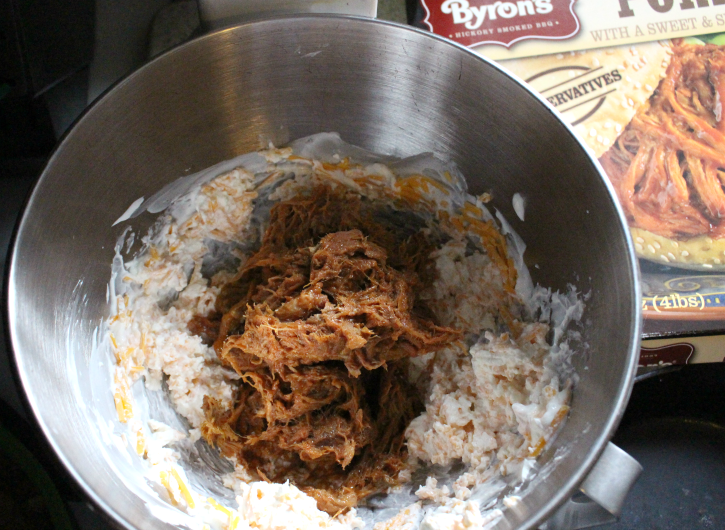 BBQ Pulled Pork being added to mixing bowl