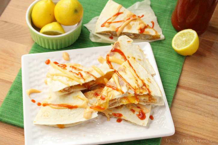 Firecracker Shrimp Quesadilla - Quesadilla but into triangles and topped with spicy mayo and hot sauce