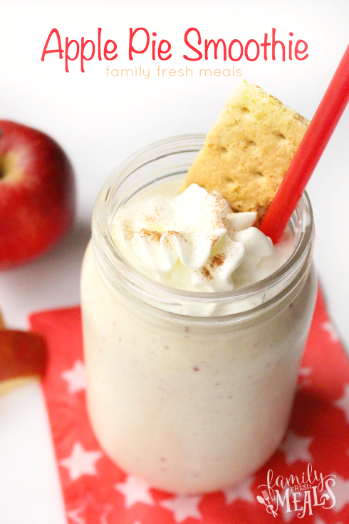 Apple Pie Smoothie in a glass jar, topped with whipped cream and a graham cracker