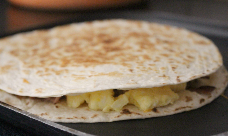 Freezer Breakfast Quesadillas - place eggs on tortilla and cook