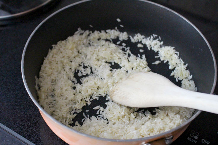 toast rice in pan with onion and butter