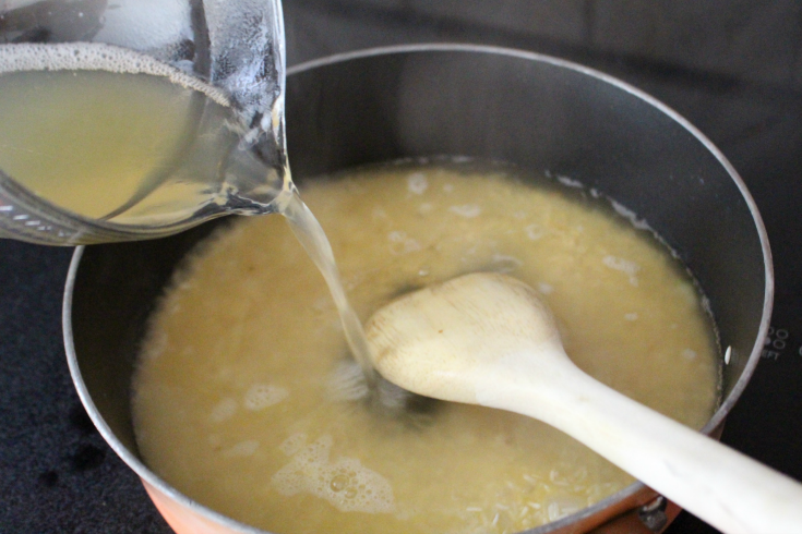 Adding in  liquid to pan