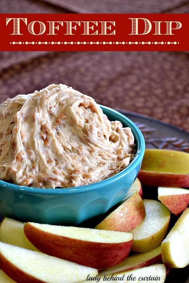Toffee Dip in a blue bowl surrounded by sliced apples