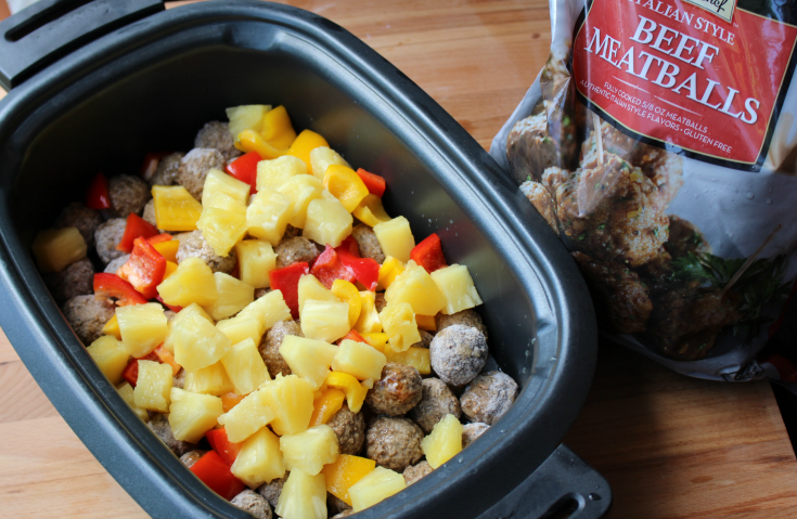 Sweet and Sour Crockpot Meatballs - Frozen meatballs with pineapple and peppers in a slow cooker