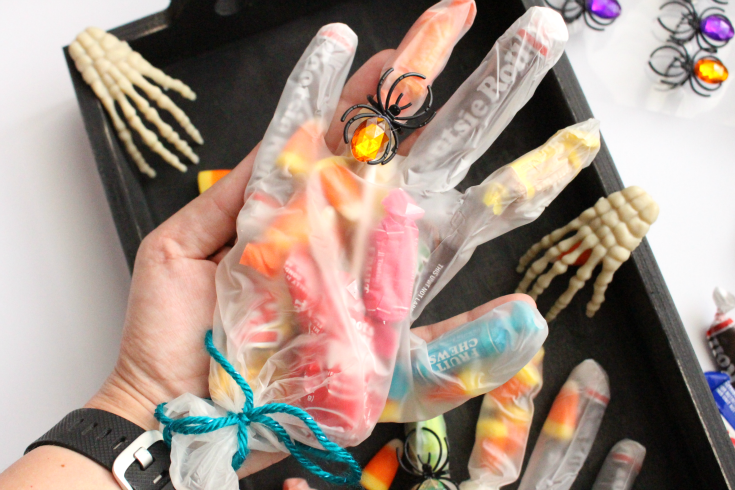 rubber glove filled with candy, with a spider ring