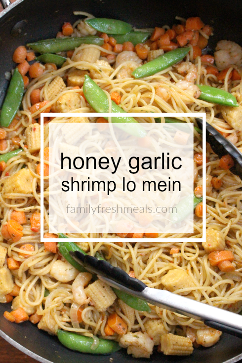 Honey Garlic Shrimp Lo Mein in a pan with tongs