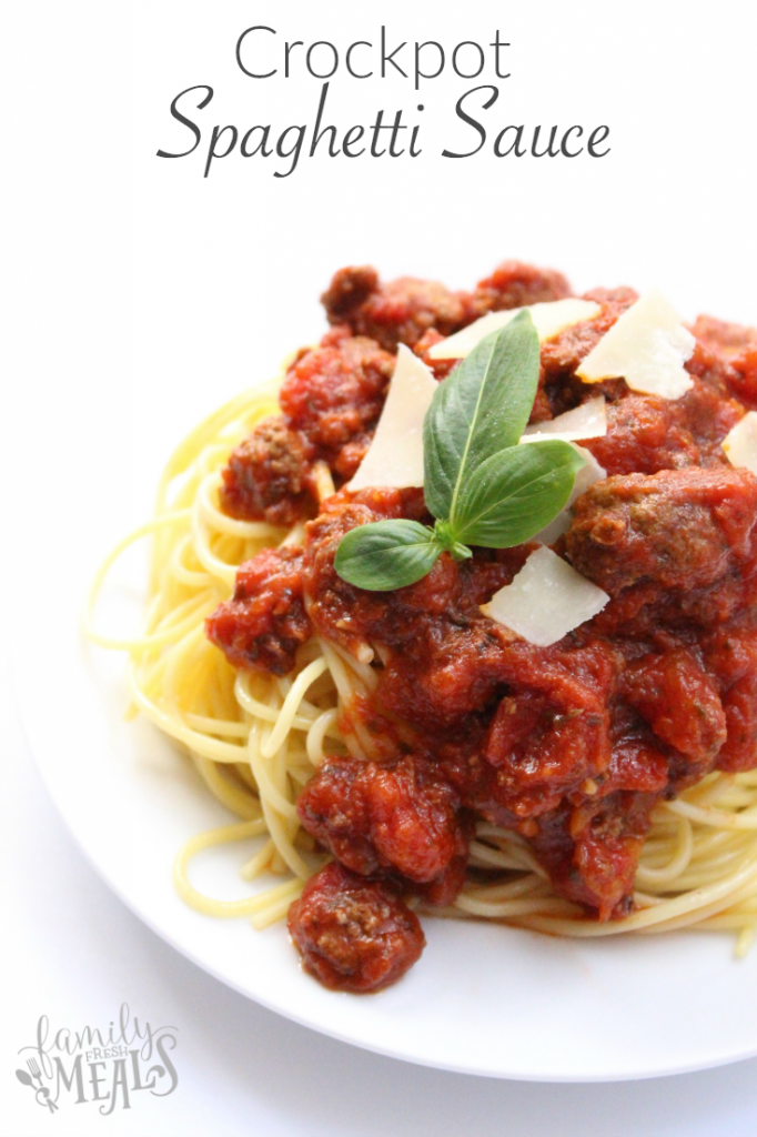 Spaghetti topped with meat sauce and basil