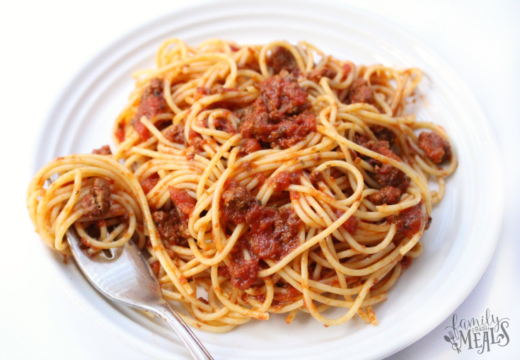 Crockpot Spaghetti and meat sauce on a white plate with a fork