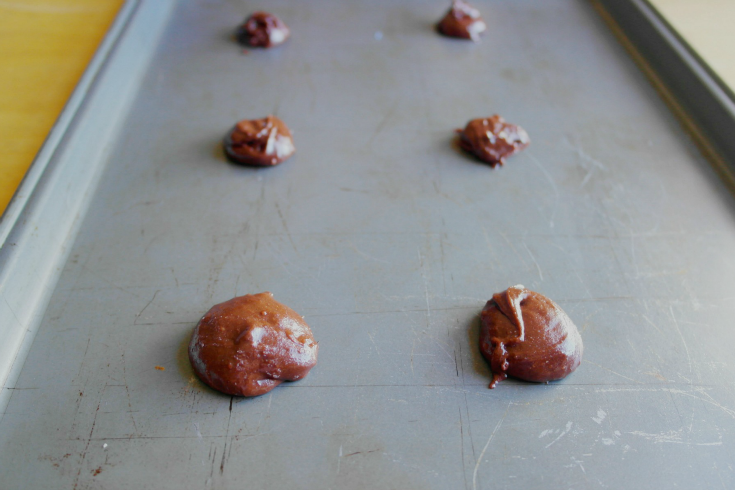 Brownie batter dropped on a baking sheet