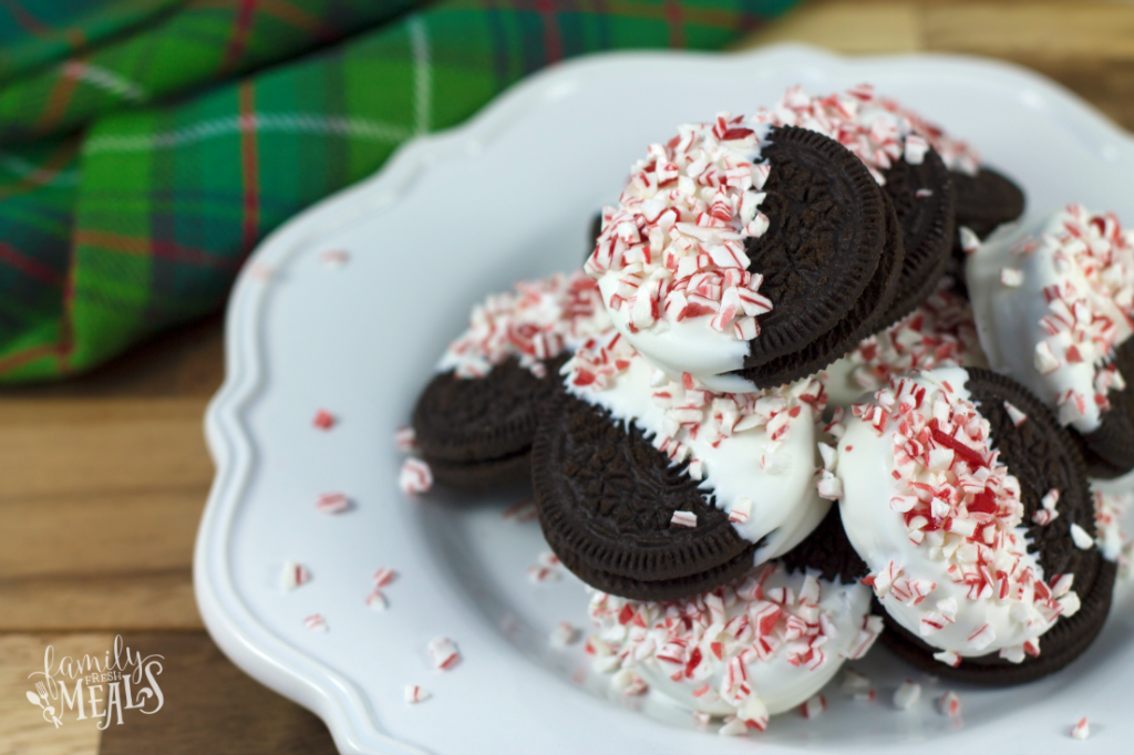 Peppermint Bark Oreos stacked on a white plate