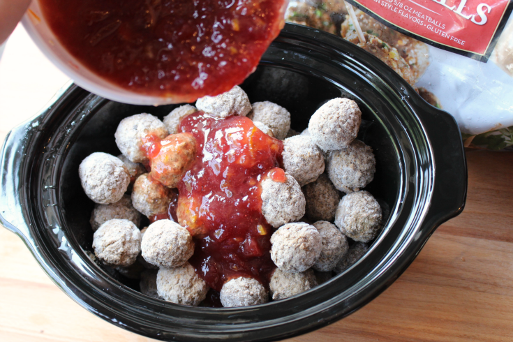 Pouring sauce over frozen meatballs