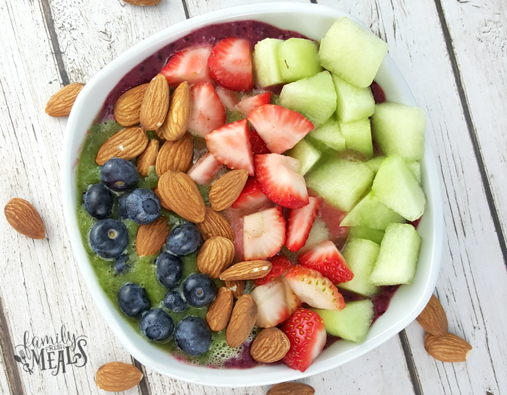 Berry Green Smoothie Bowl topped with fresh fruit and almonds