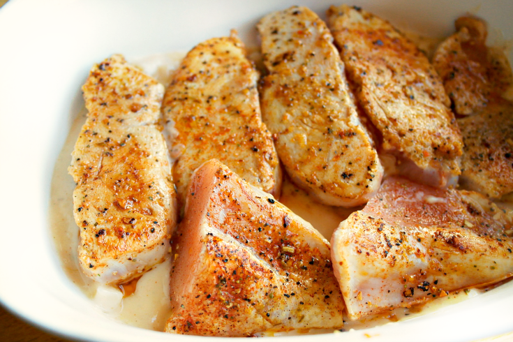 pieced of chicken in a baking dish