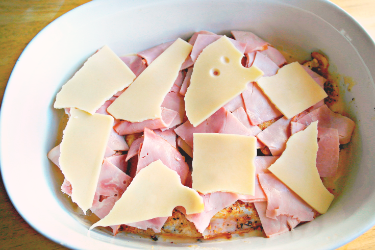 ham and sliced cheese added to the top of chicken