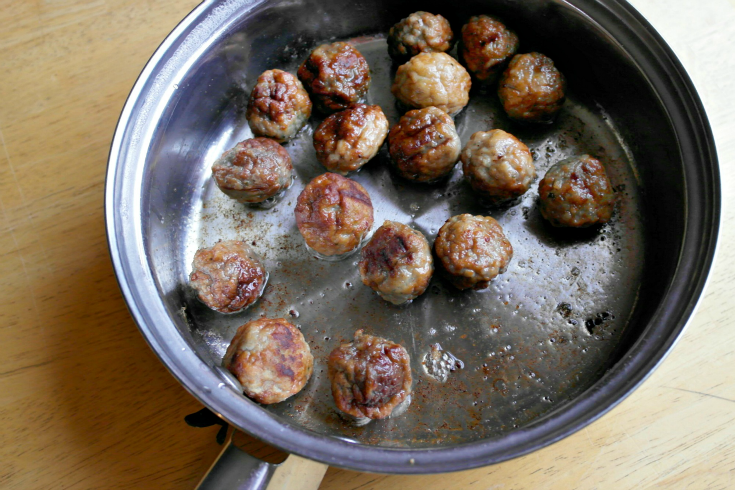 meatballs cooking in a pan