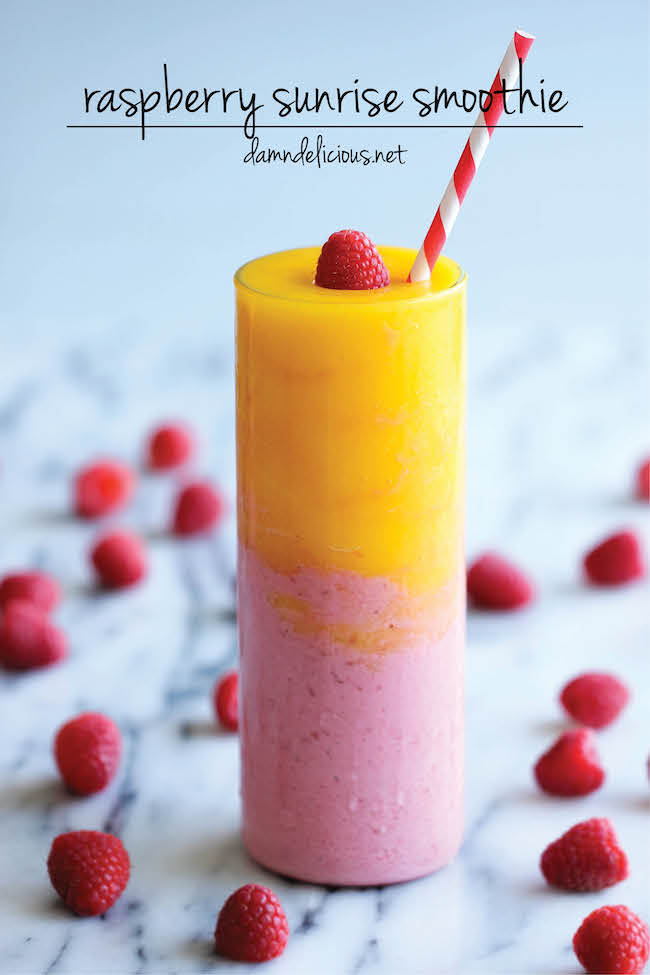 raspberry sunrise smoothie surrounded by fresh raspberries