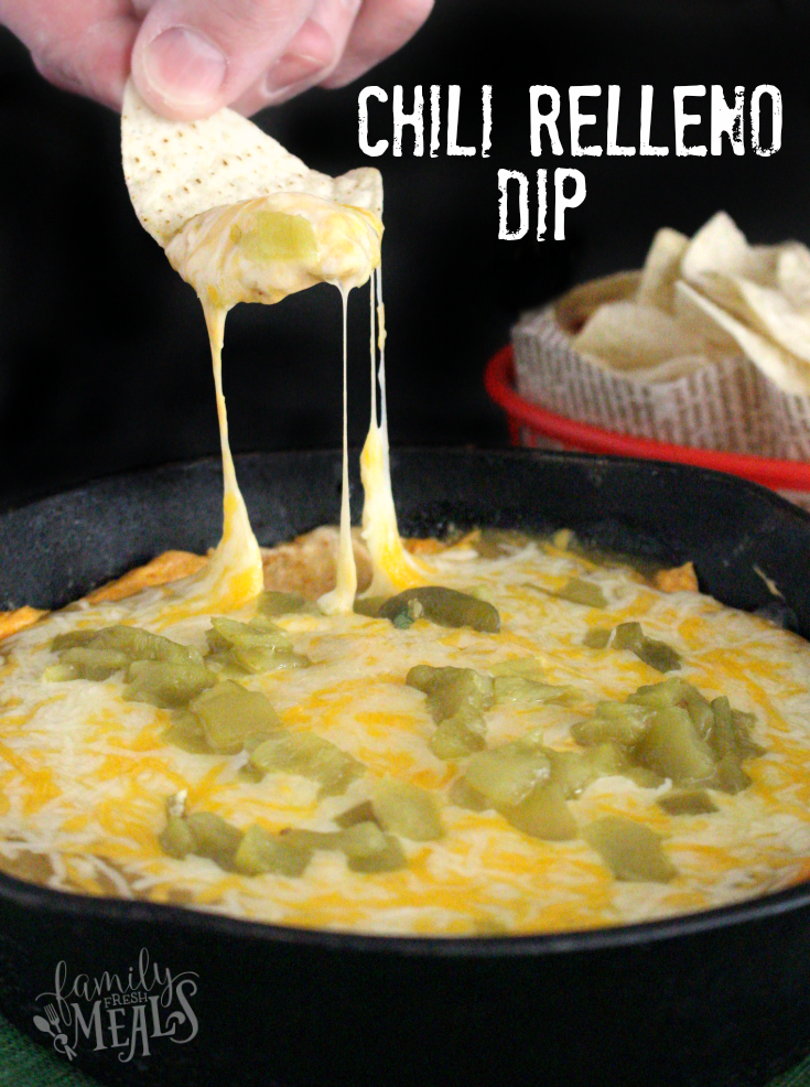 hand scooping up some Chili Relleno Dip with a tortilla chip