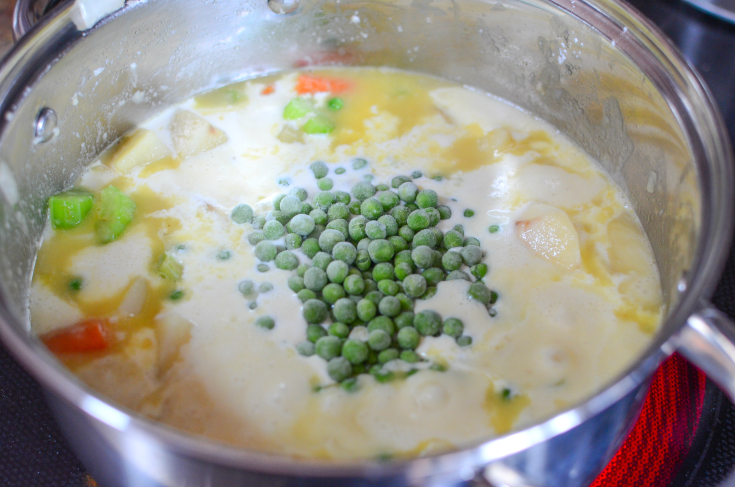 The Best Homemade Chicken Pot Pie - Sauted vegetables with broth, cream and peas