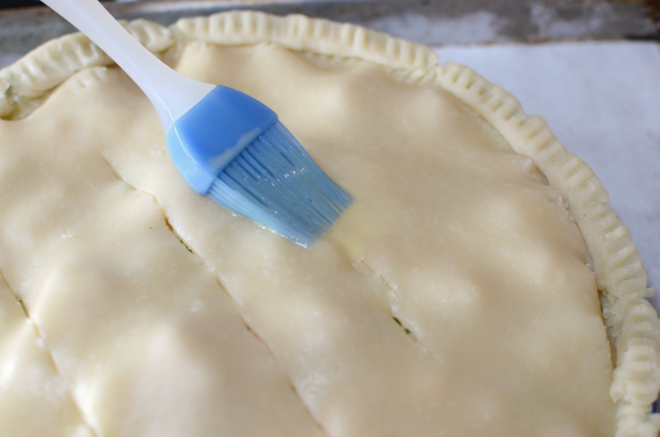 The Best Homemade Chicken Pot Pie - Pie being brushed with egg wash