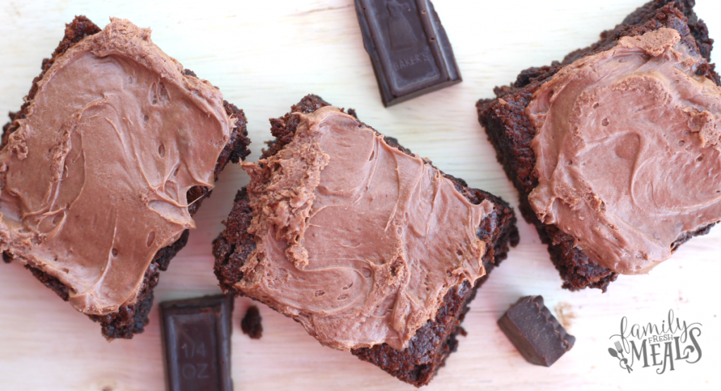 3 brownies and chocolate pieces on a cutting board