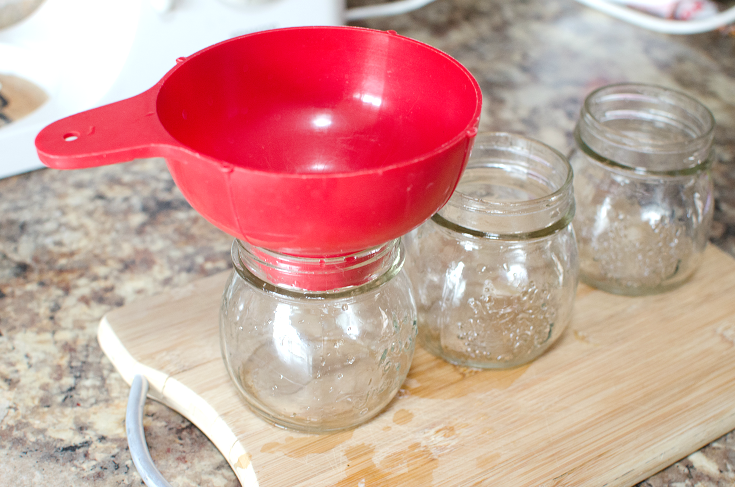 Easy Strawberry Rhubarb Jam - Red funnel in glass jars