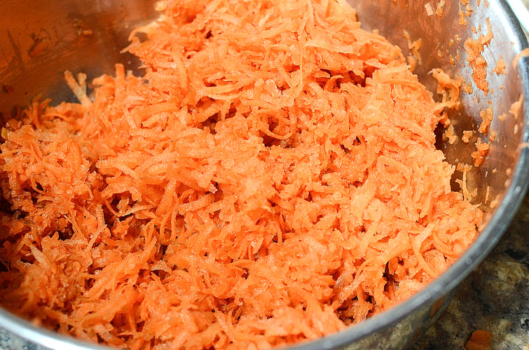 CopyCat Chick Fil A Carrot Raisin Salad Recipe - Shredded carrots in a bowl