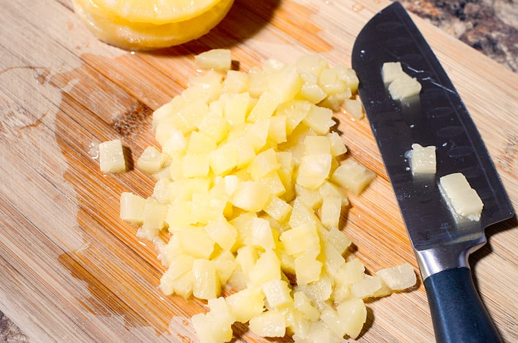 CopyCat Chick Fil A Carrot Raisin Salad Recipe - Diced pineapples on cutting board