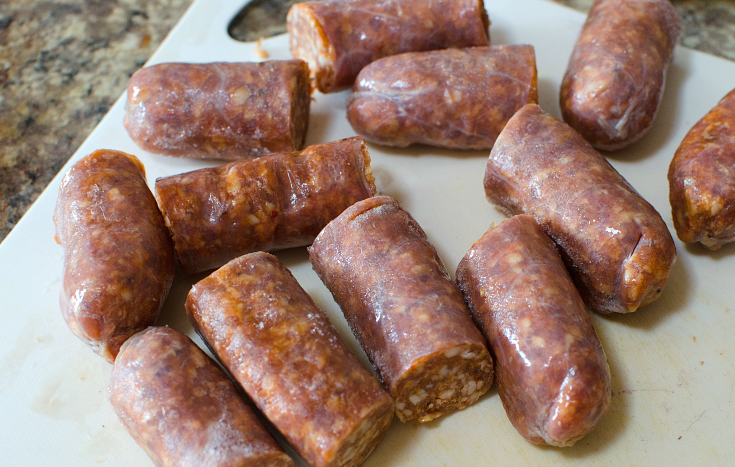 Easy Sausage Vegetable Bake - sausage cut into 2 in ch pieces on cutting board