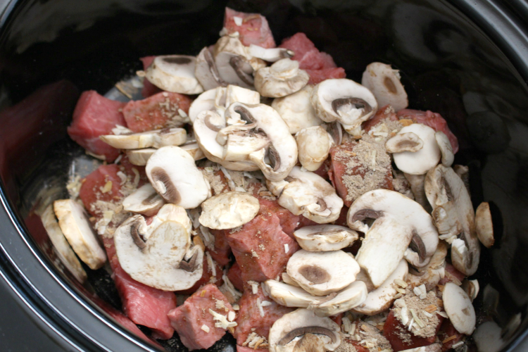 Easy Crockpot Beef Burgundy - Sliced mushrooms, seasoning and beef in a slow cooker